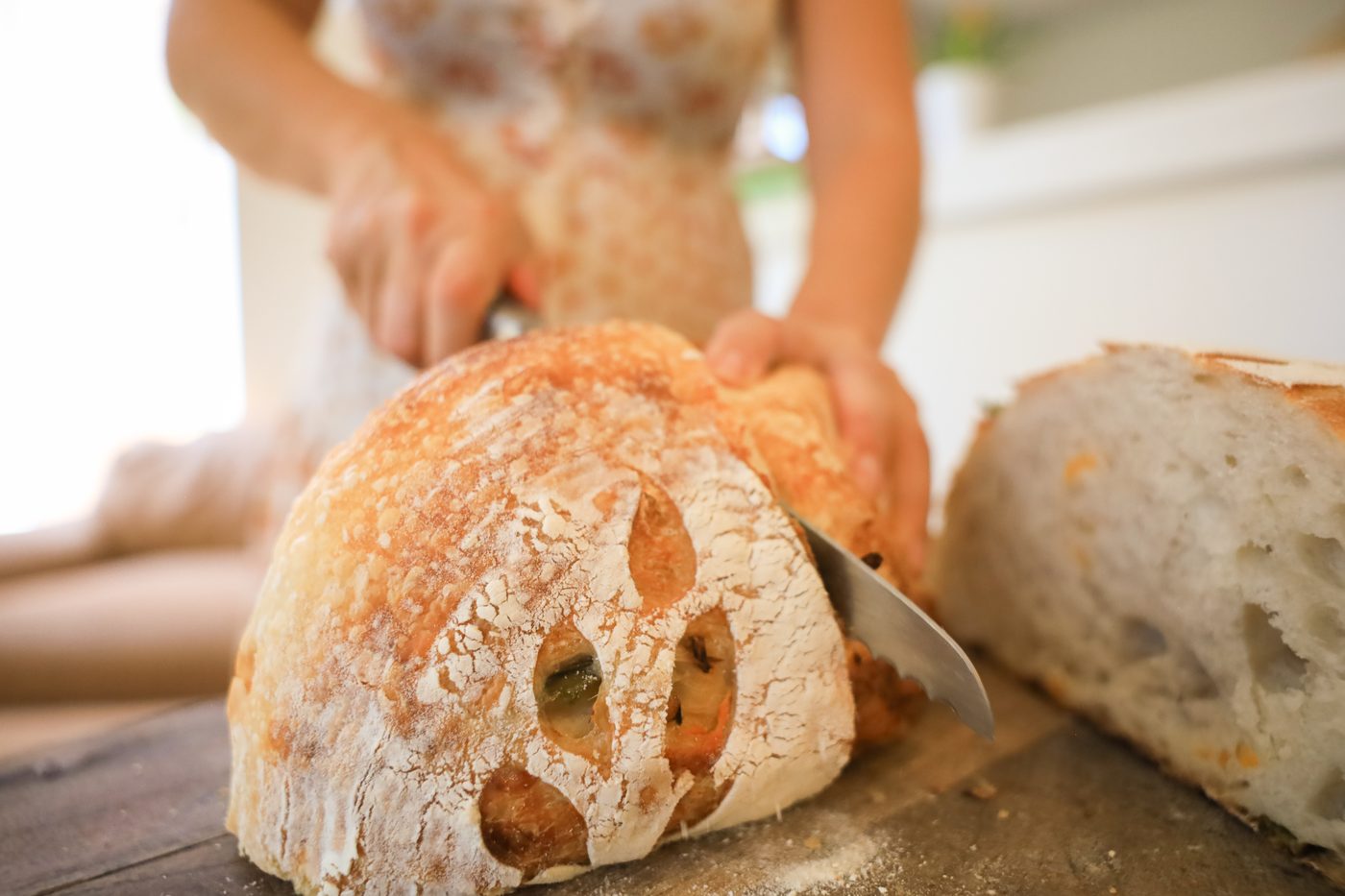 Slicing into a fresh loaf, still crackling from the oven