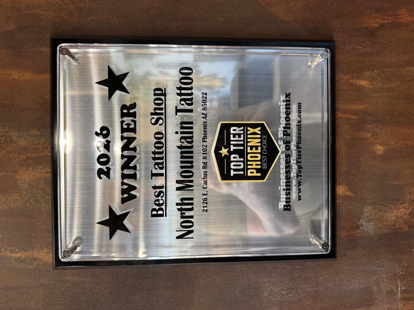 The Top Tier Phoenix 2026 Best Tattoo Shop plaque at North Mountain Tattoo